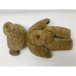 1950s sheepskin plush covered teddy bear with musical movement, the revolving head with applied eyes, leather nose and stitched mouth, jointed limbs with leather pads H50cm