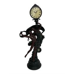 Decorative contemporary “Mystery Clock” with battery operated quartz movement, movement supported by two figures in a classical pose on a circular base, dial inscribed “Juliana”.
