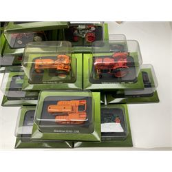 Eighteen issues of Tractors and The World of Farming magazine, together with sixty diecast tractors, all in original packaging, in three boxes 
