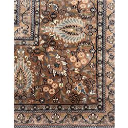 Large Persian indigo ground rug, the busy field decorated with trailing branches and flower heads, peach border decorated with palmettes -