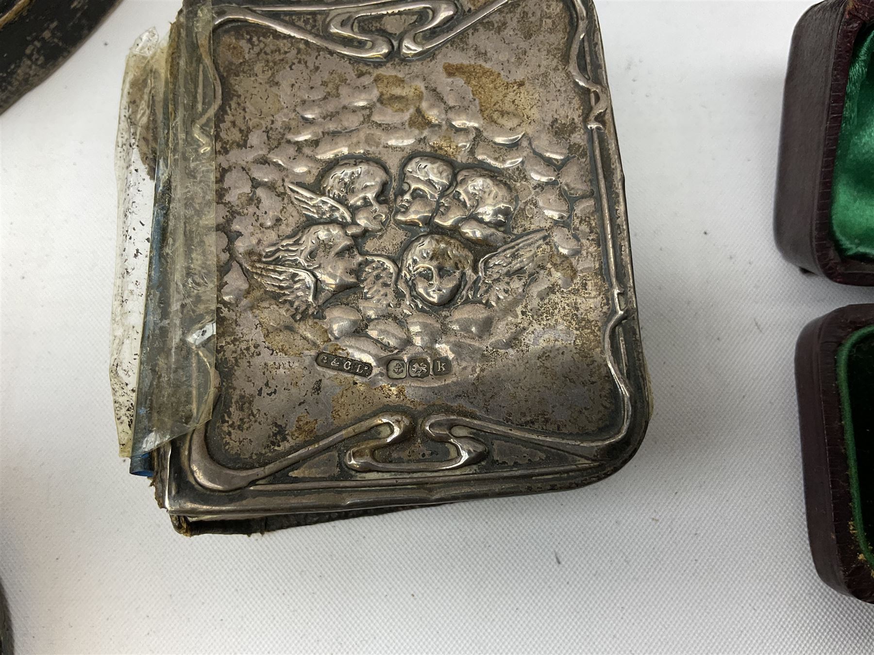 Group of silver, to include filled figure of a pheasant, hallmarked for London, pair of silver mounted horn napkin rings, miniature Edwardian bible with silver cover embossed with putti, Victorian silver brooch, ebonised plinth with applied inscribed silver shields, etc., together with two stick pins, one example with 9ct gold terminal 