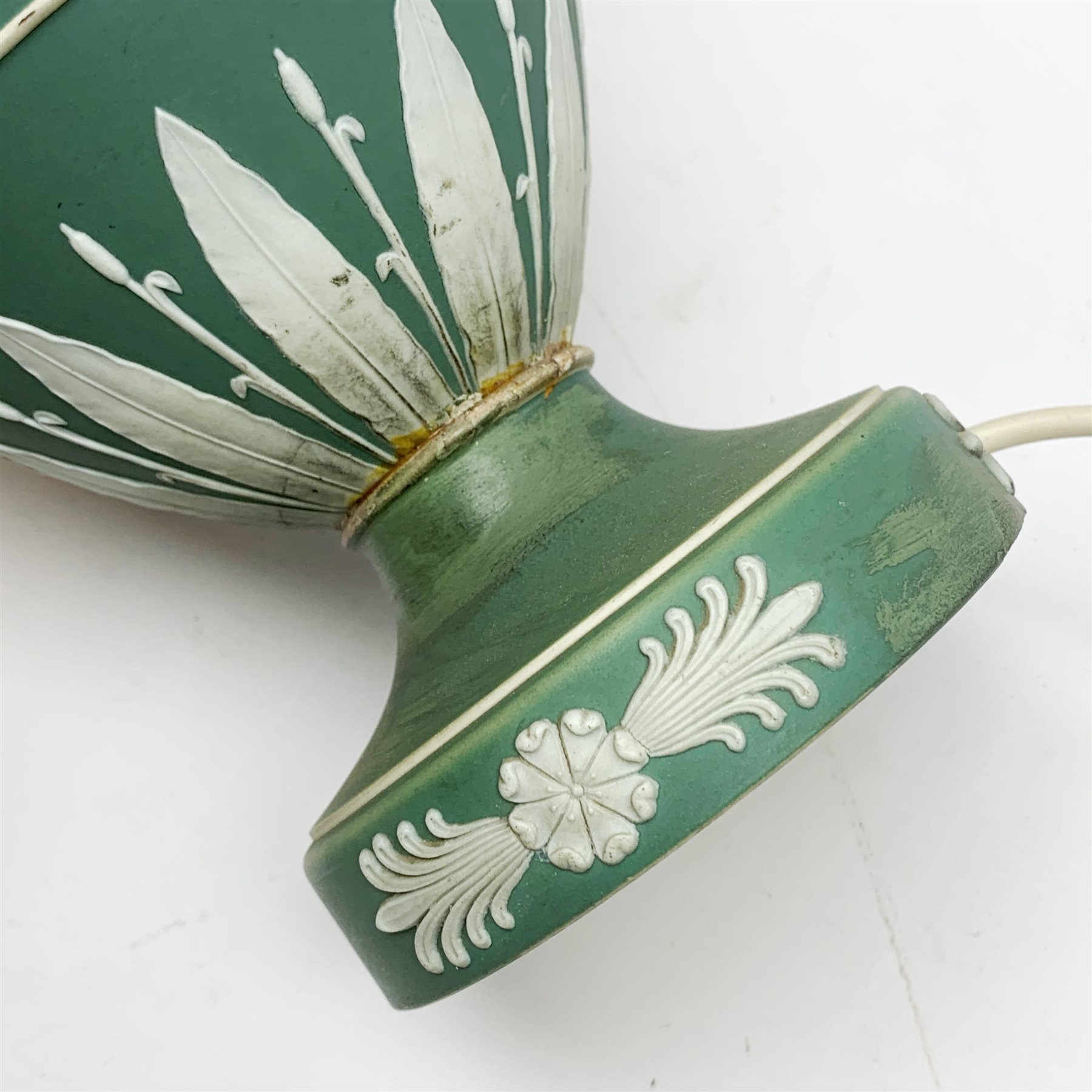 A Wedgwood green Jasperware table lamp, of ovoid form upon a spreading circular foot, decorated with dancing hours, with cream shade, overall H44.5cm. 