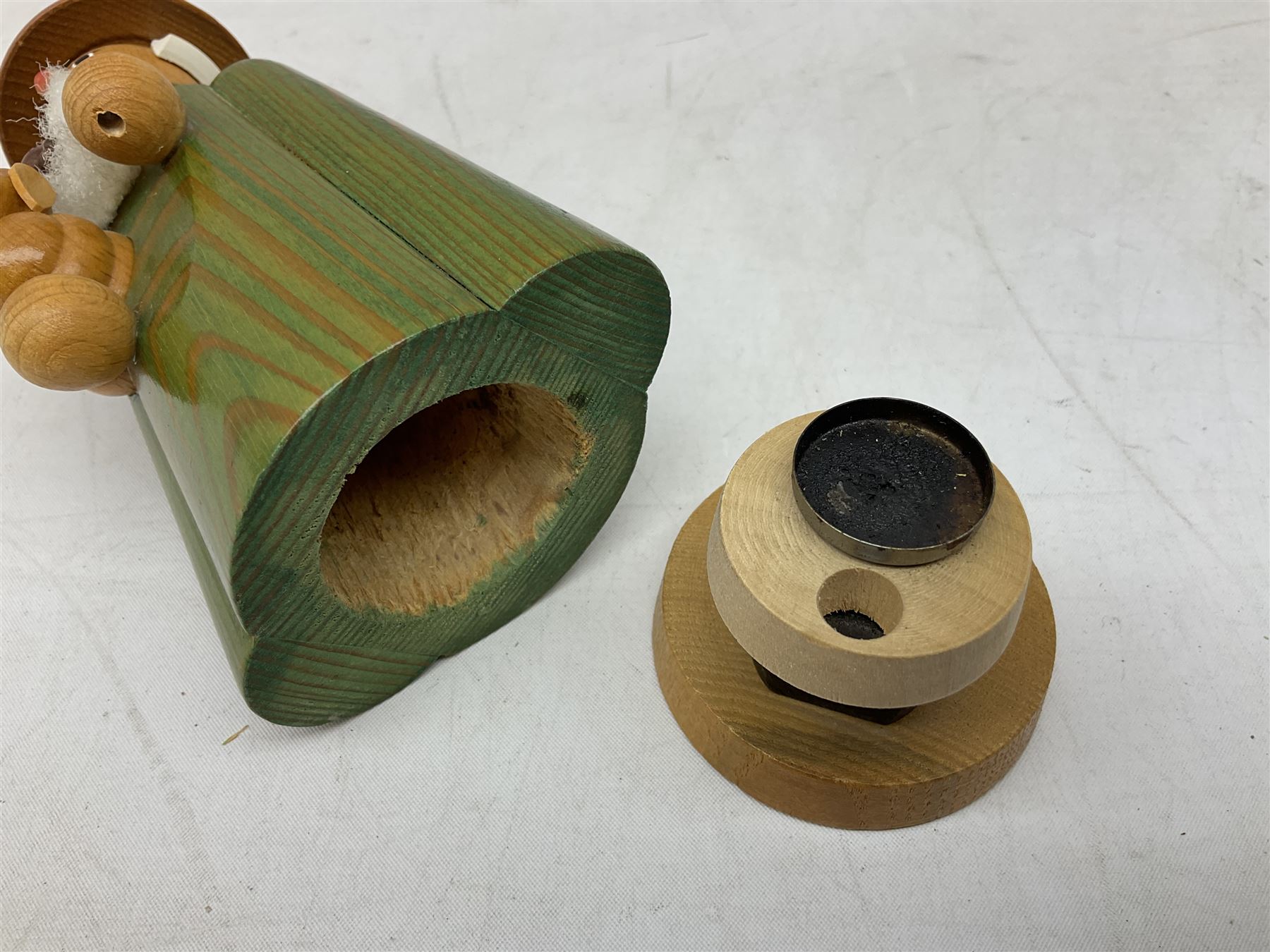 German Erzgebirgische Volkskunst folk art carved and stained wood smoking men incense burner figure, modelled smoking a pipe, with sticker label beneath, H19cm