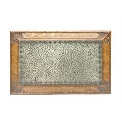 Arts and Crafts oak stand by Arthur Simpson of Kendal, of rectangular form with central hammered pewter panel, surrounded by a border with carved foliate corners, upon two bar supports, bearing label detailed 