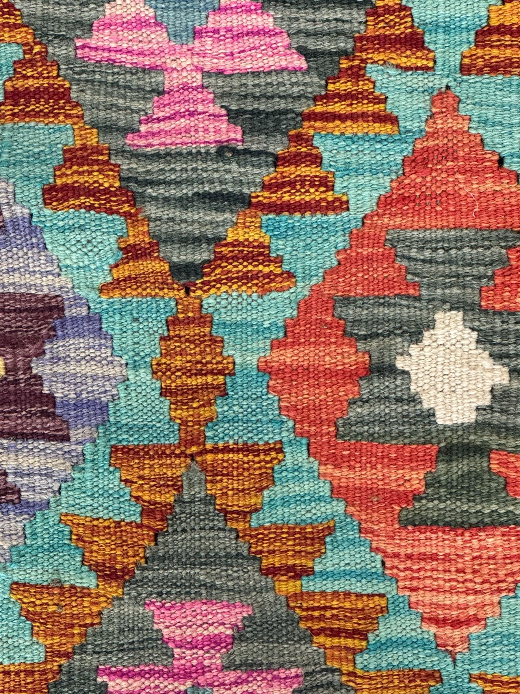 Tibetan-design handwoven rug, deep red field with three central medallions in yellow and blue, traditional yellow key border, white fringes on both ends