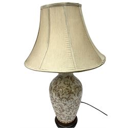 Pair of ceramic table lamps, with foliage decoration and a wooden base H50cm, together with two lampshades. 