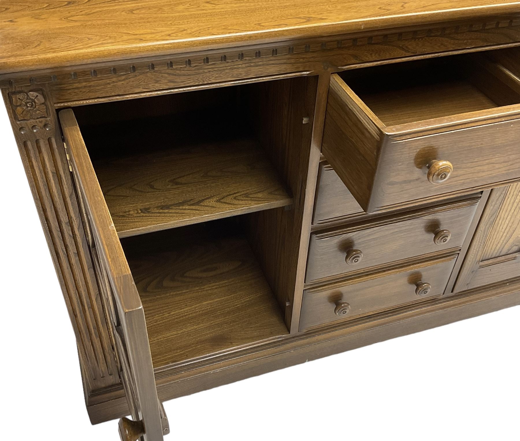 Ercol - mid-20th century dark elm 'Old Colonial' dresser, two tier plate rack with fluted uprights, base fitted with four drawers flanked by two panelled cupboards