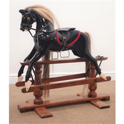  19th century painted rocking horse, saddle stirrups and briddle, trestle base, L90cm, H86cm  