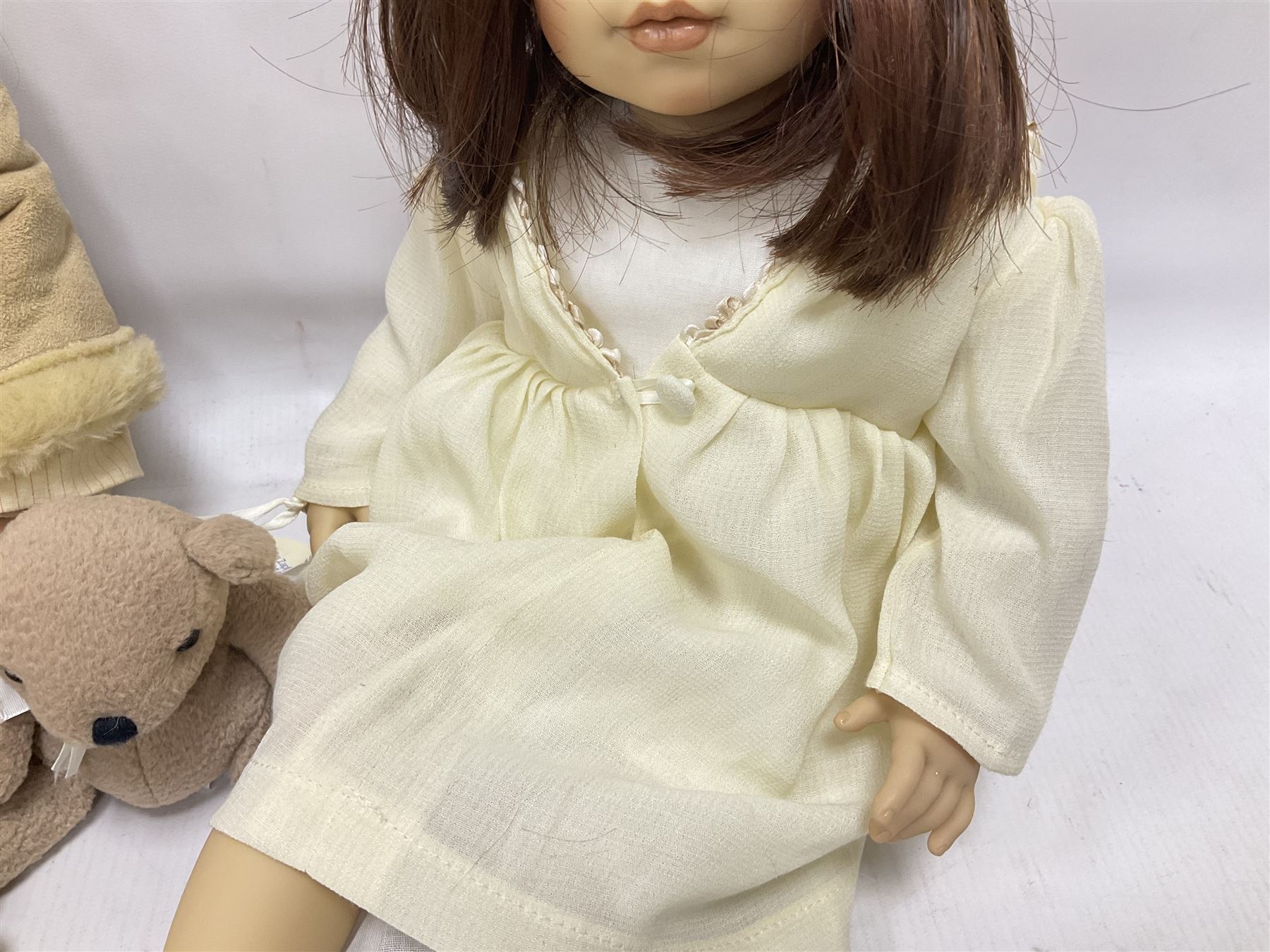 Two Zapf Creation limited edition designer collection dolls, by Brigette Paetsch, the first example with faux suede jacket, red jumper and denim skirt, no. 460, the second example 'Linda' in white dress with teddy bear accessory, no. 785, each signed B Paetsch, tallest L60cm