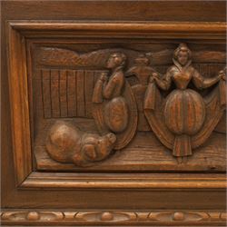 Carved oak coffer bench, rectangular moulded top above carved fall front, with figural, mask and foliate decoration, panelled sides, raised on turned bun feet with shaped lower apron