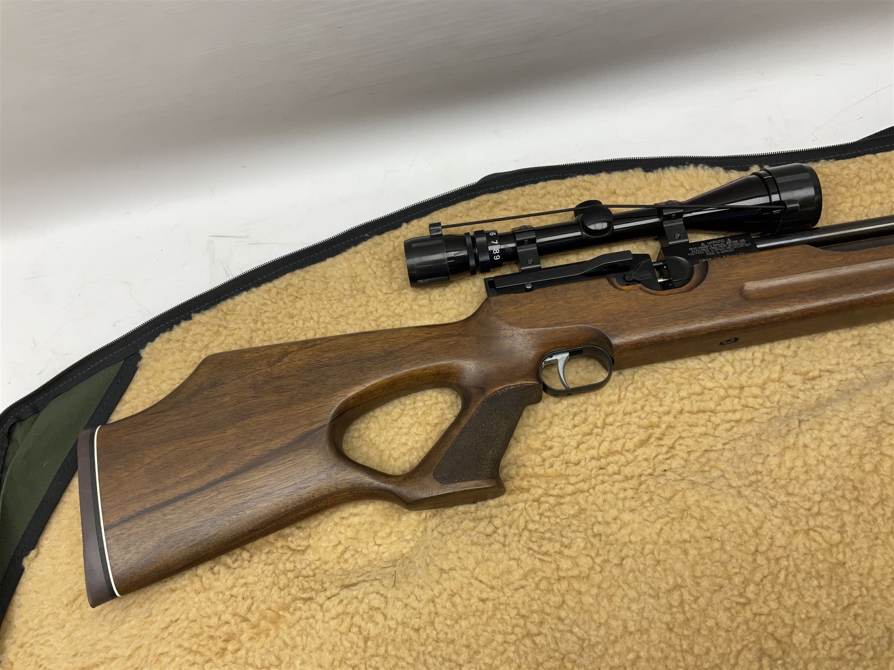 Weihrauch HW100 .22 calibre PCP repeating air rifle; walnut thumbhole stock with textured pistol-grip; Nikko Stirling Silver Crown 3-9x40 telescopic sight; integral sound moderator; No.1901181 L99cm overall; in gun sling; with Logun Combi-Pump and quantity of pellets