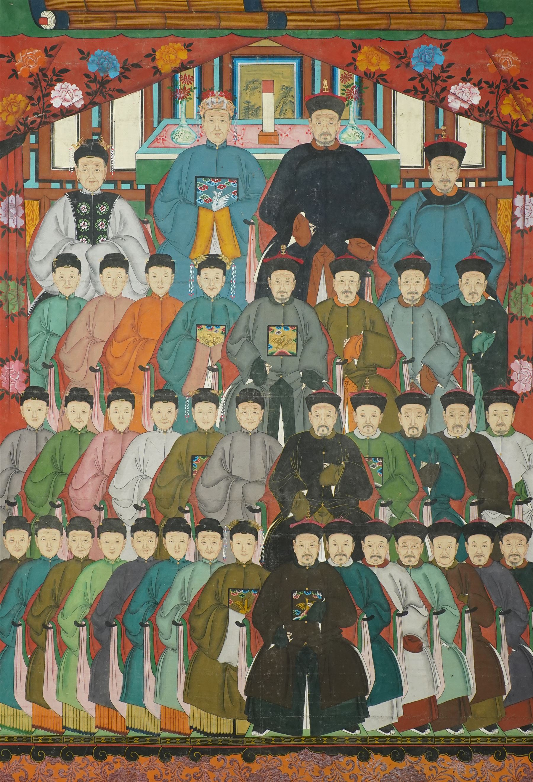 Large and impressive Chinese ancestral portrait, late Qing dynasty, gouache on stitched canvas with gilded highlights, showing thirty-eight sitters across four registers, the principal ancestors depicted before an altar table holding various ritual items, each in official dress and many wearing Golden Pheasant (Second-rank) and Silver Pheasant (Fifth-rank) Mandarin squares or 'buzi', overall 190cm x 131cm 