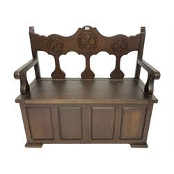 20th century stained beech hall bench or pew, the back carved with stylised rosettes, over hinged box seat, with loose seat cushion