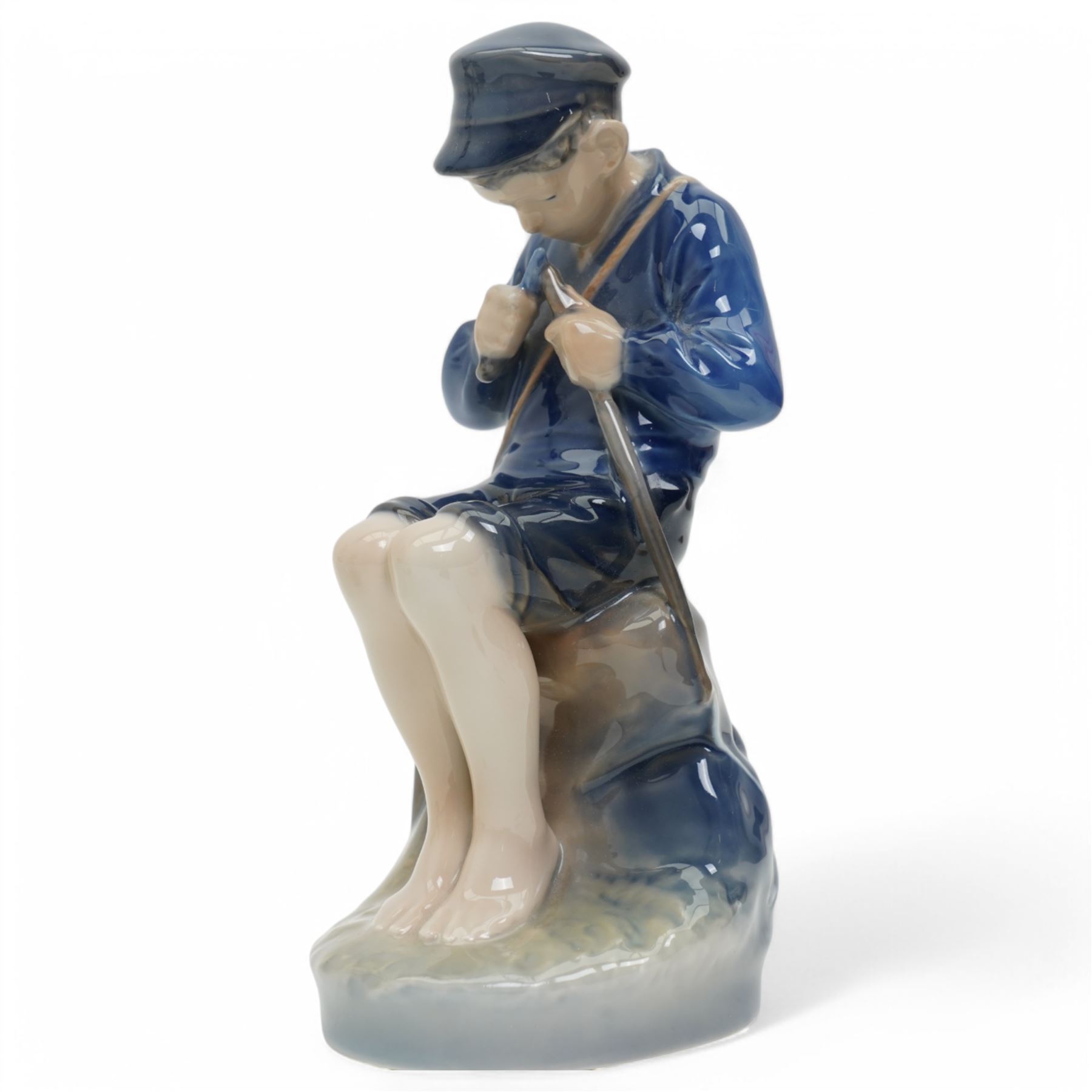 Four Royal Copenhagen figures, including Amager Girl Sewing no. 1314, Boy Whittling no. 905, Girl with Goose no. 528, and Amager Girls Reading no. 1395