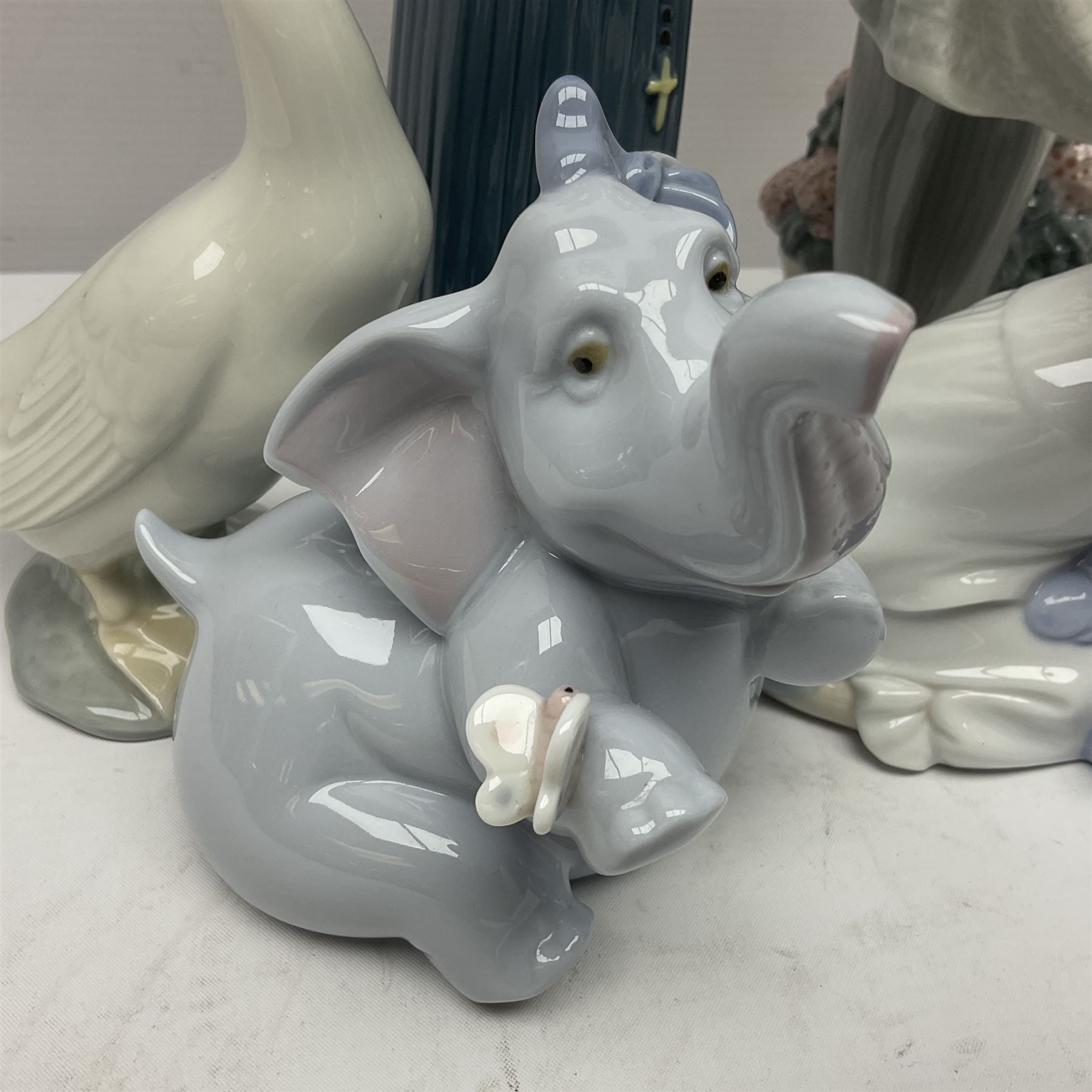 Two Lladro figures, Over the Threshold no 5282 and Prayful Moment no 5500 together with five Nao figures