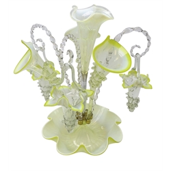  Victorian vaseline glass epergne with central trefoil rim trumpet surrounded by six alternate jack-in-the-pulpit trumpets with trailing clear glass mounts and barley twist canes supporting flower head baskets, on fluted circular base, H41cm  