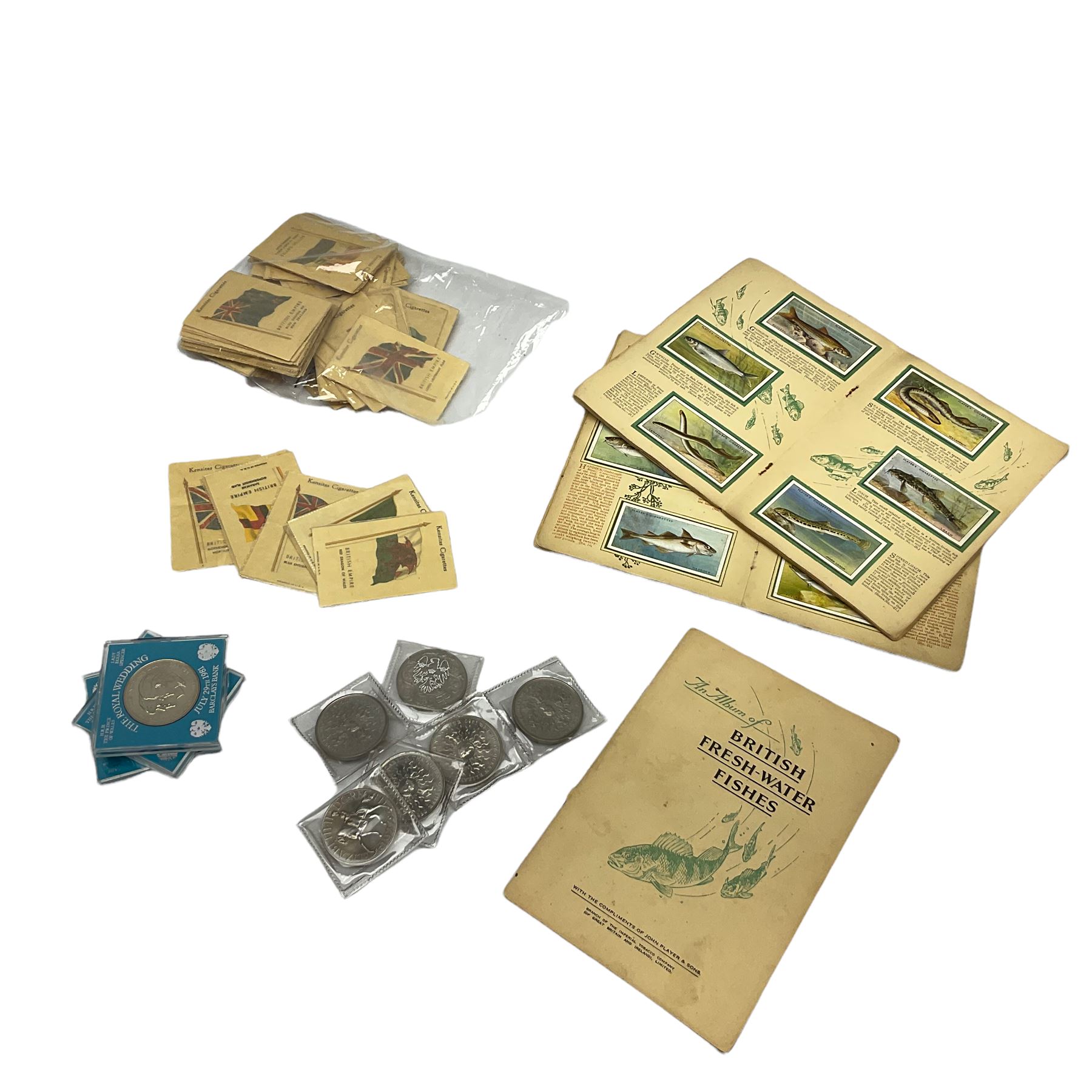 Quantity of Kensitas silk cigarette cards depicting world flags, together with albums of fish cigarette cards and quantity of crowns to include boxed examples