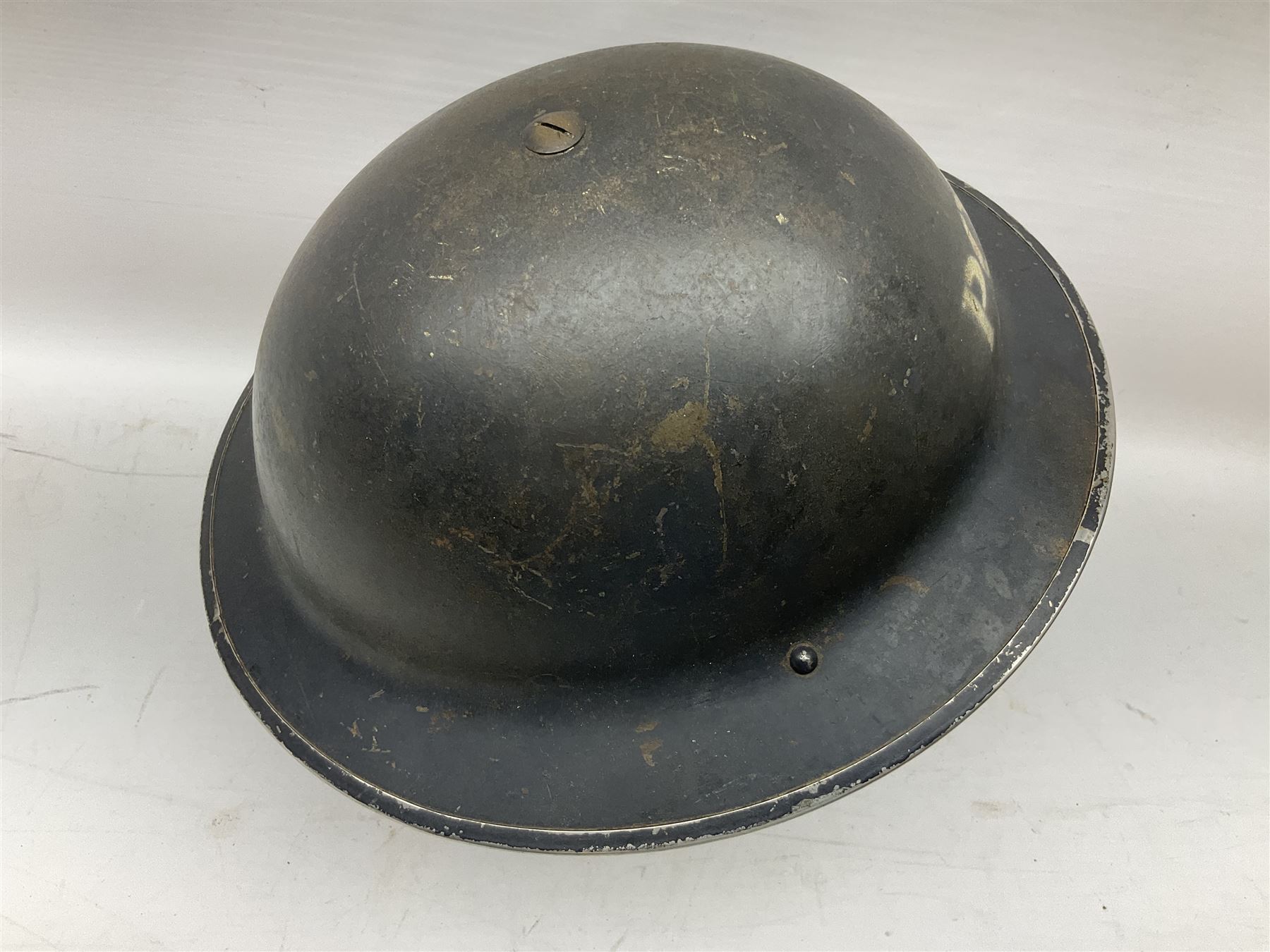 WW2 Home Front 'Police' black painted steel helmet with original liner and webbing chin strap, impressed R.O. Co. 1/1939; and re-painted shell only for WW2 Wardens steel helmet impressed AMC II 1941 C676 (2)