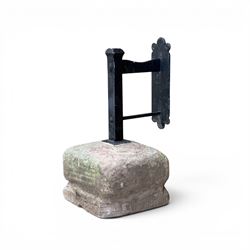Large wrought metal boot scraper in black painted finish, set in formed stone plinth
