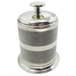 Mid 20th century Art Deco style silver mounted Bakelite table cigarette dispenser, of cylindrical form with engine turned decoration, the cover rising to reveal a compartmented interior with four brass dividers, upon a short spreading circular foot, hallmarked Joseph Gloster Ltd, Birmingham 1951, H11.5cm