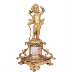 Pair of 19th century ormolu putto figures, each modelled stood with foliate support to backs, upon a naturalistic base upon cylindrical plinth each with twin leafy tendril supports, each plinth with inset Sevres type painted panel of a cherub, upon a shaped base with four compressed disk feet, the front facing with leaf mount, H29cm