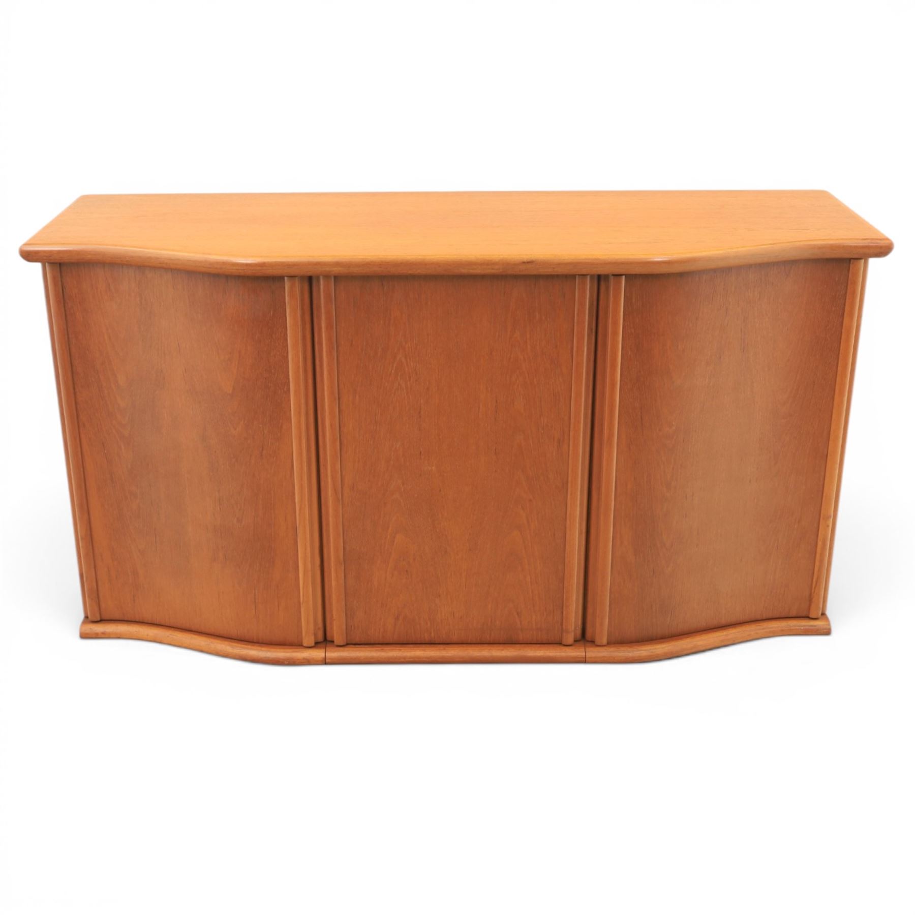 Skovby - model '400T' teak sideboard, shaped top above three cupboard doors with recessed handles, fitted with shelving and drawers