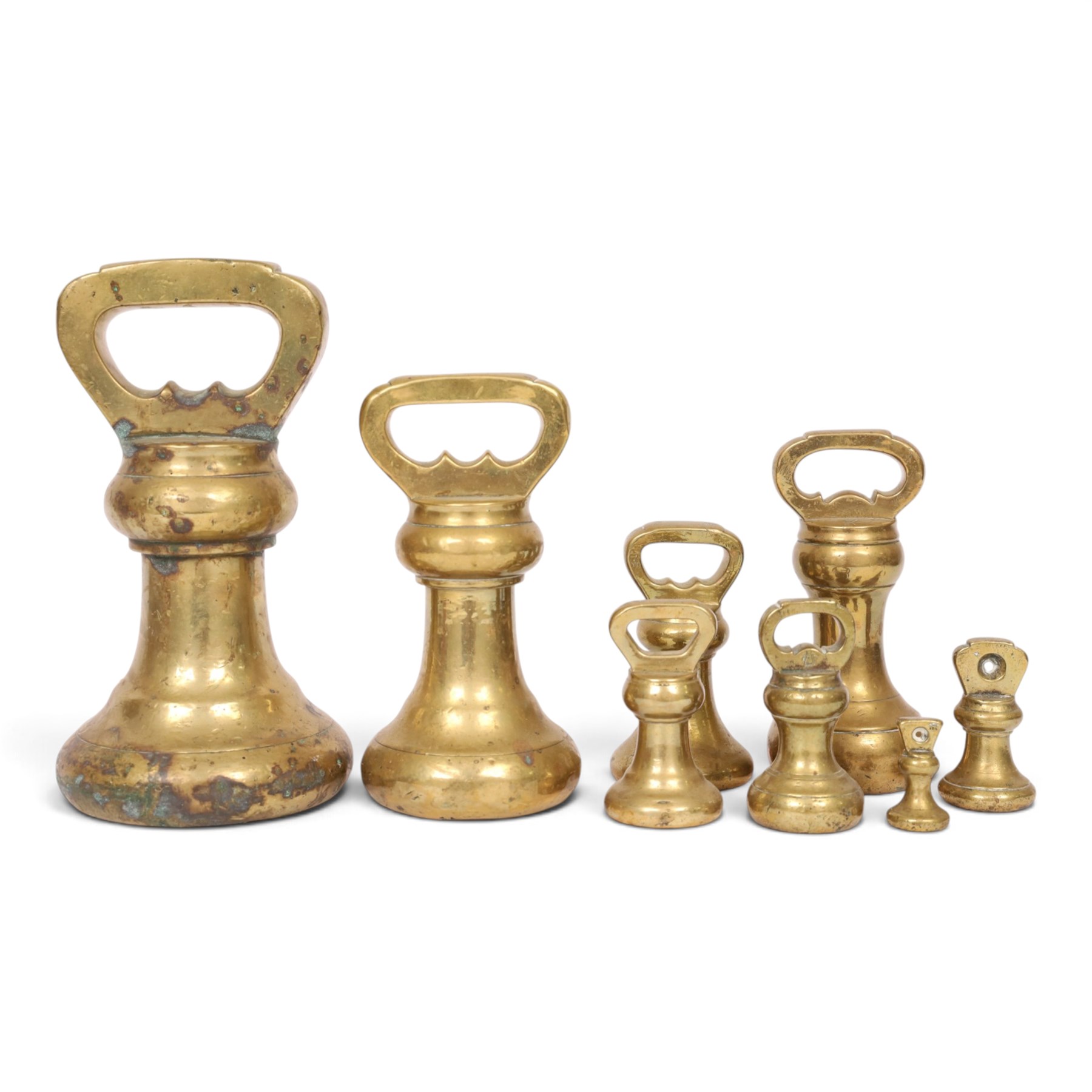 Graduating set of brass bell weights