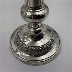 Four George III silver candlesticks, each upon knopped stem and weighted circular stepped foot, the foot and removable sconce repousse decorated with a band of flower heads, hallmarked to sconce and foot Thomas & John Settle, Sheffield 1820, H17.5cm