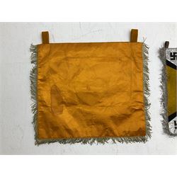 Two replica German Luftwaffe trumpet banners, one heavily silver wire embroidered with Luftwaffe eagle in a wreath, on an amber, white and black rayed background, , with silver wire tasselled border and four leather hanging loops, approx. 50 x 49cm; the other slightly larger heavily gold wire embroidered with the Luftwaffe eagle on a plain amber ground with gold wire tasselled border and two hanging loops (2)