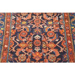 Large vintage Persian Hamadan indigo ground runner rug, the busy field with central ivory medallion and spandrels, surrounded with Herati motifs and stylised plant symbols, with multiple floral decorated guard bands