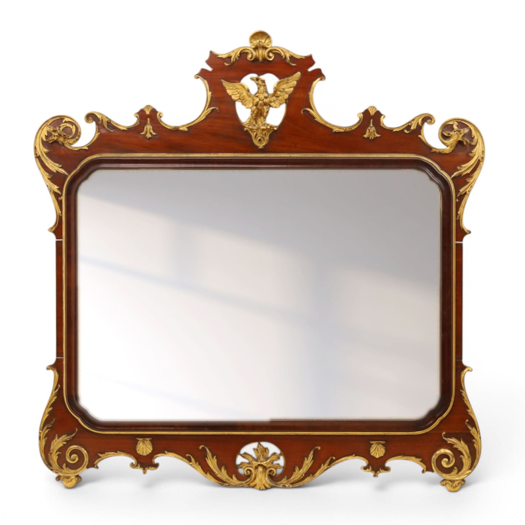 Large George III mahogany wall mirror, parcel gilt shaped frame with scrolling acanthus, shell and foliate decoration, surmounted by carved gilt ho-ho bird, rectangular mirror plate within moulded border, shaped apron with gilt scroll terminals, removed from a Scottish country estate