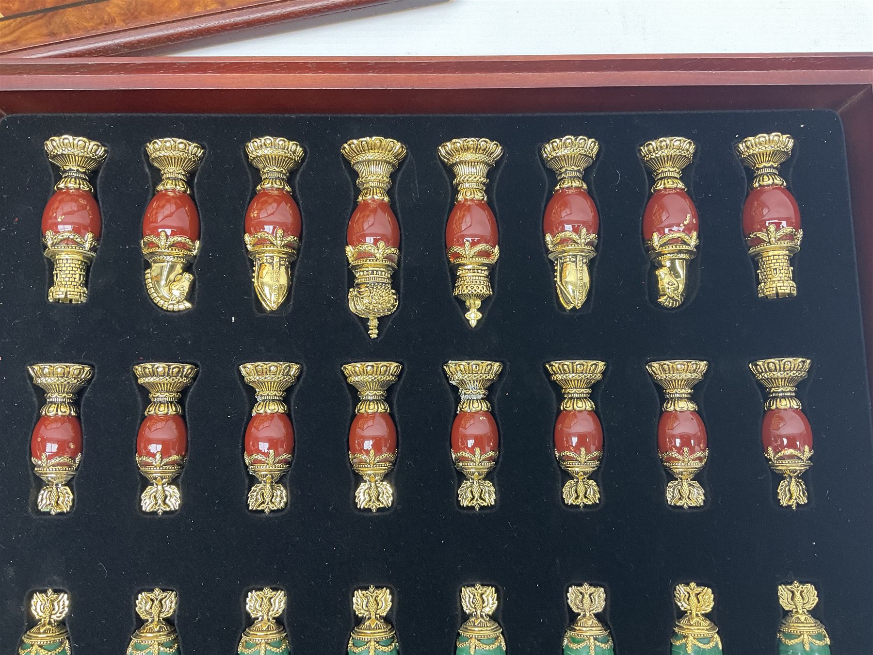 Franklin Mint House of Faberge 'The Imperial Jewelled Chess Set', to include set of chess pieces with malachite finish and a set with carnelian finish and a hardwood chess board