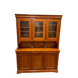 Multi-York -  Loire cherry wood dresser, shaped cornice over three glazed doors enclosing six shelves, the lower section fitted with three shallow drawers with shaped fronts over three cupboards with panelled doors, raised on plinth base with bracket feet