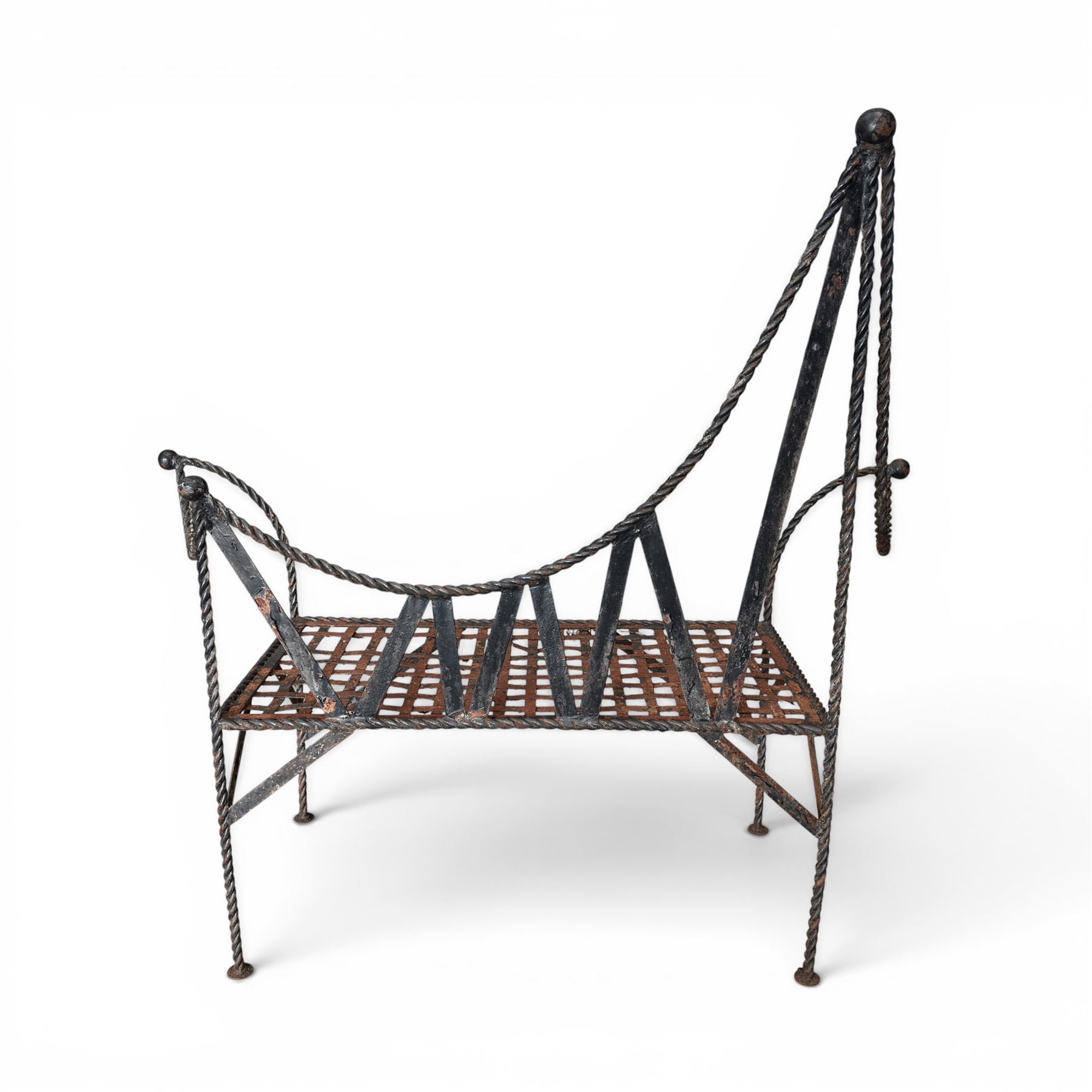Victorian design wrought iron garden bench, with asymmetrical rope-twist frame, arched back and sides over out-swept arm terminals with ball finials, flanking a lattice seat, in antique black-painted weathered finish