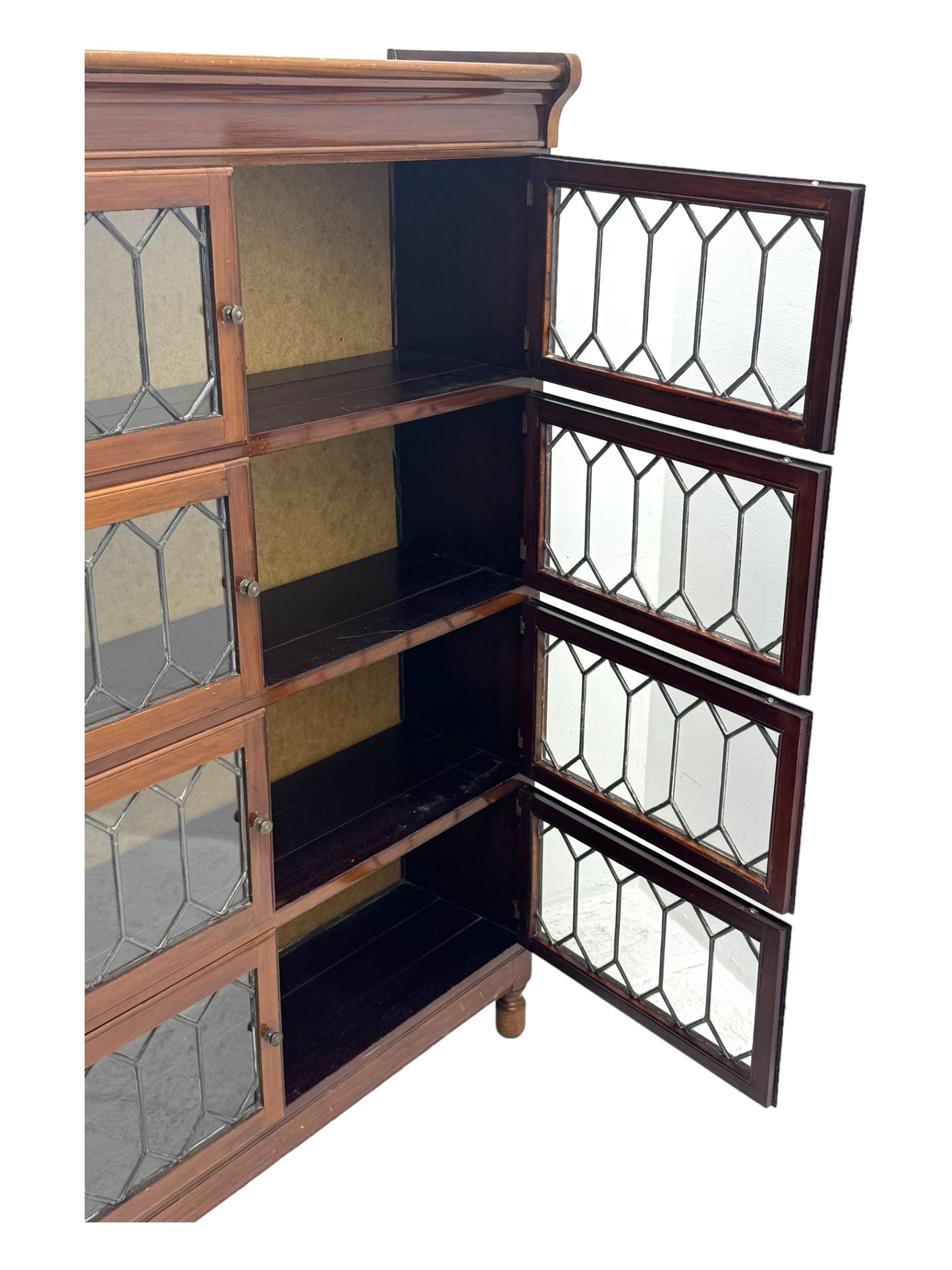 Early 20th century Globe Wernicke design stacking walnut bookcase, fitted with four sections each with two leaded glass doors, raised on turned feet