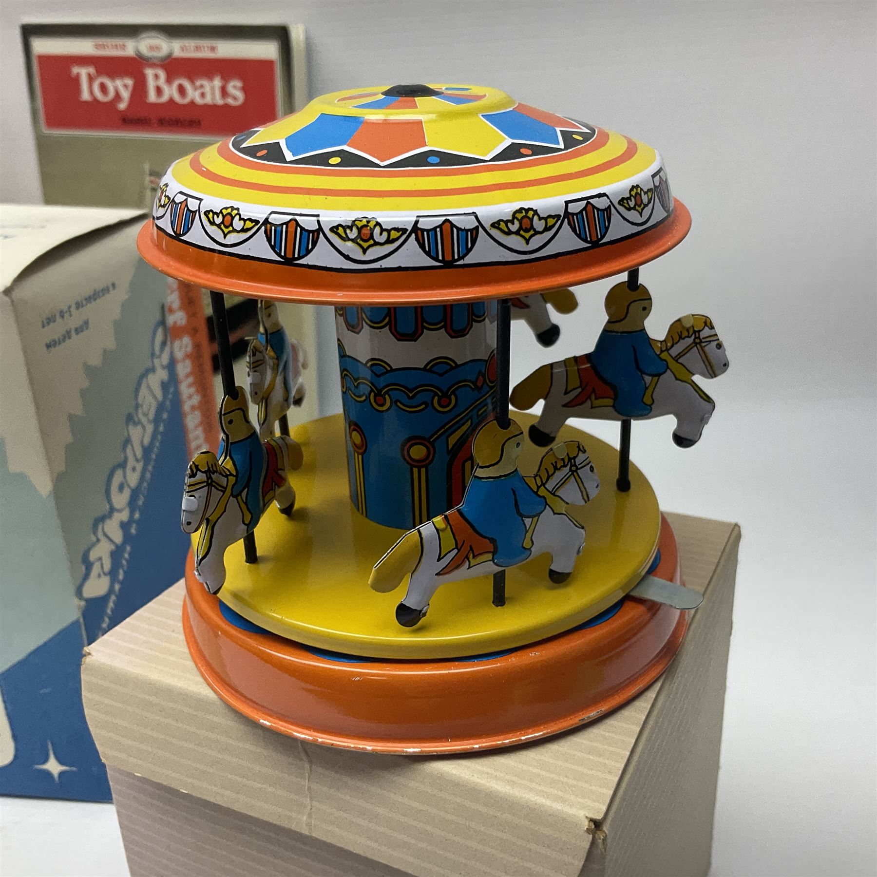 Twenty six tinplate models to include Ferris Wheel and Performing Circus Elephant, marked JW, further similar examples such as Duck on a Bike, Clown on Roller, Carousel; Popeye Tin Speedboat; Looney Tunes Wind Up Cars and Express Train; various international examples, MS107 Jumping Bambi, Pop Pop Boat, jumping frogs, pecking chickens etc; both boxed and loose