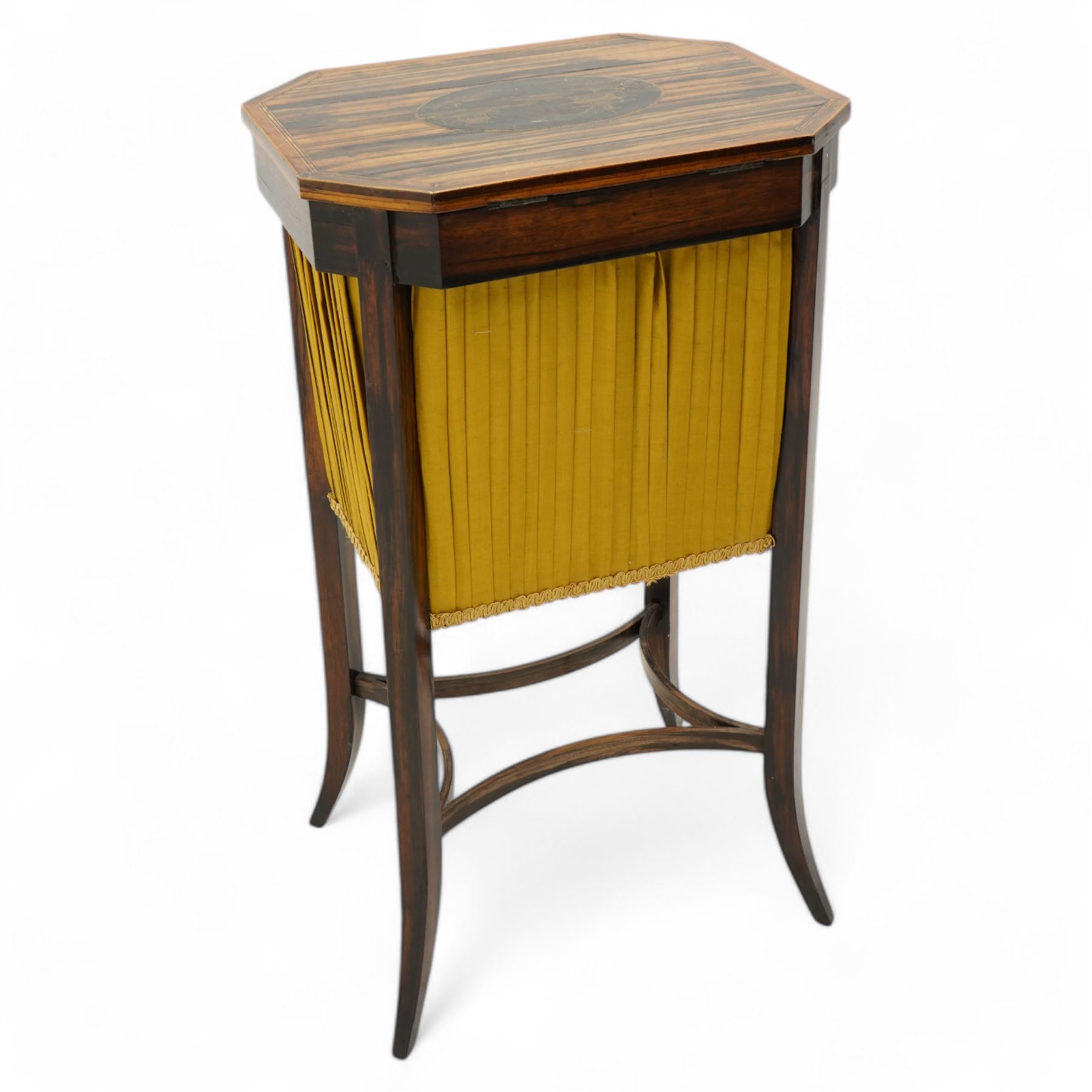 Edwardian coromandel wood work or sewing table, canted rectangular form, the hinged lid with central chinoiserie panel depicting traditional scene with boat, enclosing sunken storage well with pleated skirt, on square tapering supports with splayed feet united by curved stretchers 