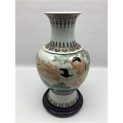 Chinese famille verte vase, of baluster form with fluted rim, the body decorated with five nude female figures amongst water and trees, with bands of polychrome foliate and floral decoration to base and rim, with six character Qianlong mark beneath, upon a circular wooden base, H41.5cm
