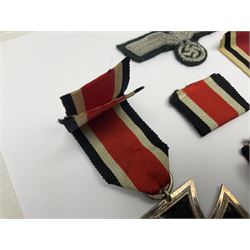 WWII German Iron Cross 2nd Class, the suspension ring stamped 128 for S. Jablonski G.m.b.H. Posen; with ribbon; together with an embroidered cloth eagle badge and quantity of German medal ribbons.