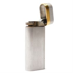 Cartier - silver-tone and gold-tone pocket lighter, with brushed vertical finish, hinged cover and gold-tone band signed Cartier, base signed Cartier and numbered, with original fitted presentation box, outer box and international guarantee booklet