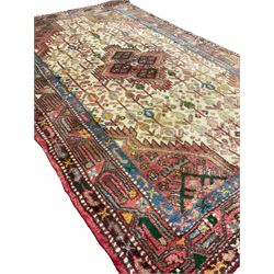 Small Persian rug, ivory and pale red ground, decorated with central medallion within a field of trailing Boteh motifs, geometric design guarded border
