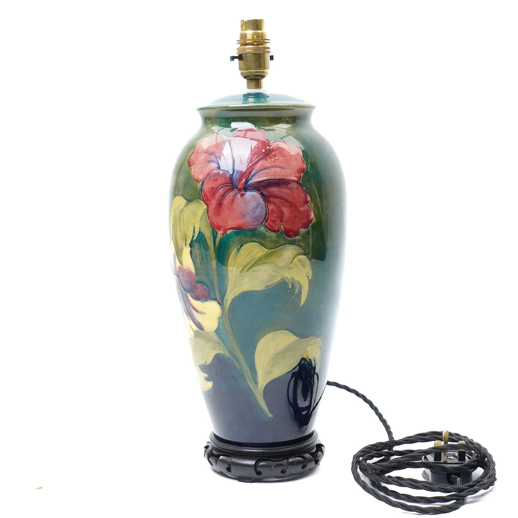 Moorcroft 'Hibiscus' pattern table lamp on green ground, including stand and fittings H42cm
