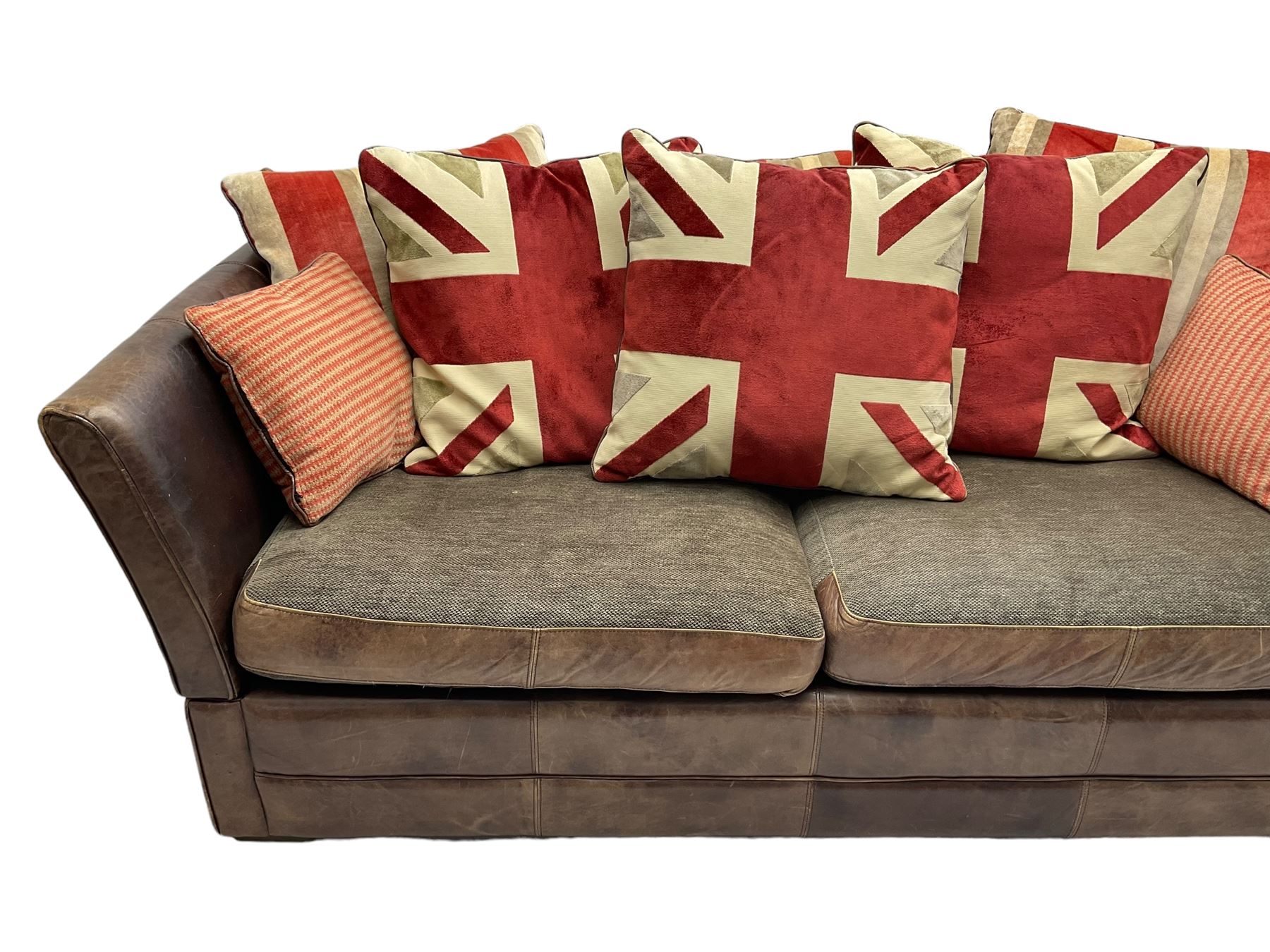Large Knole design three-seat sofa upholstered in brown leather with scatter cushions upholstered in contrasting striped and Union Jack patterned fabric, on block feet (W210cm, H100cm, D102cm); together with matching rectangular footstool (135cm x 75cm, H45cm)