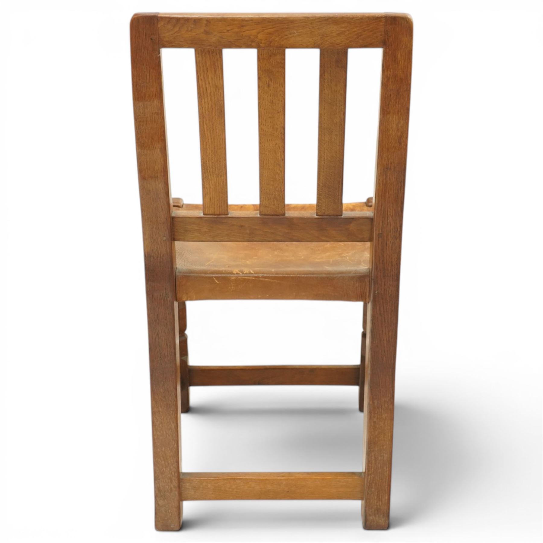 Mouseman - 1940s oak side chair, the slat-back over a slung leather seat, raised on octagonal front supports united by box stretcher, carved with slim mouse signature, by the workshop of Robert Thompson of Kilburn