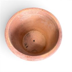 Three terracotta planters with lattice relief and rolled rim