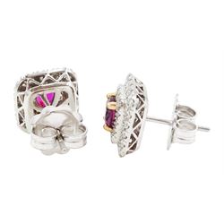 Pair of platinum ruby and diamond cluster earrings, each stud set with a single oval cut ruby in a four claw 18ct rose gold setting, surrounded by two rows of round brilliant cut diamonds, London 2017, total ruby weight approx 1.43 carat, total diamond weight approx 0.76 carat, with Alan Poultney Gems report