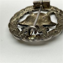 Four German awards - pre-WW2 two-position button hole ribbon for 1914 Iron Cross; WW1 wound badge open back cut-out version with silvered finish; miniature version Mother's Cross with ribbon bow; and The Eastern Medal, officially the Winter Battle in the East 1941–42 Medal (4)