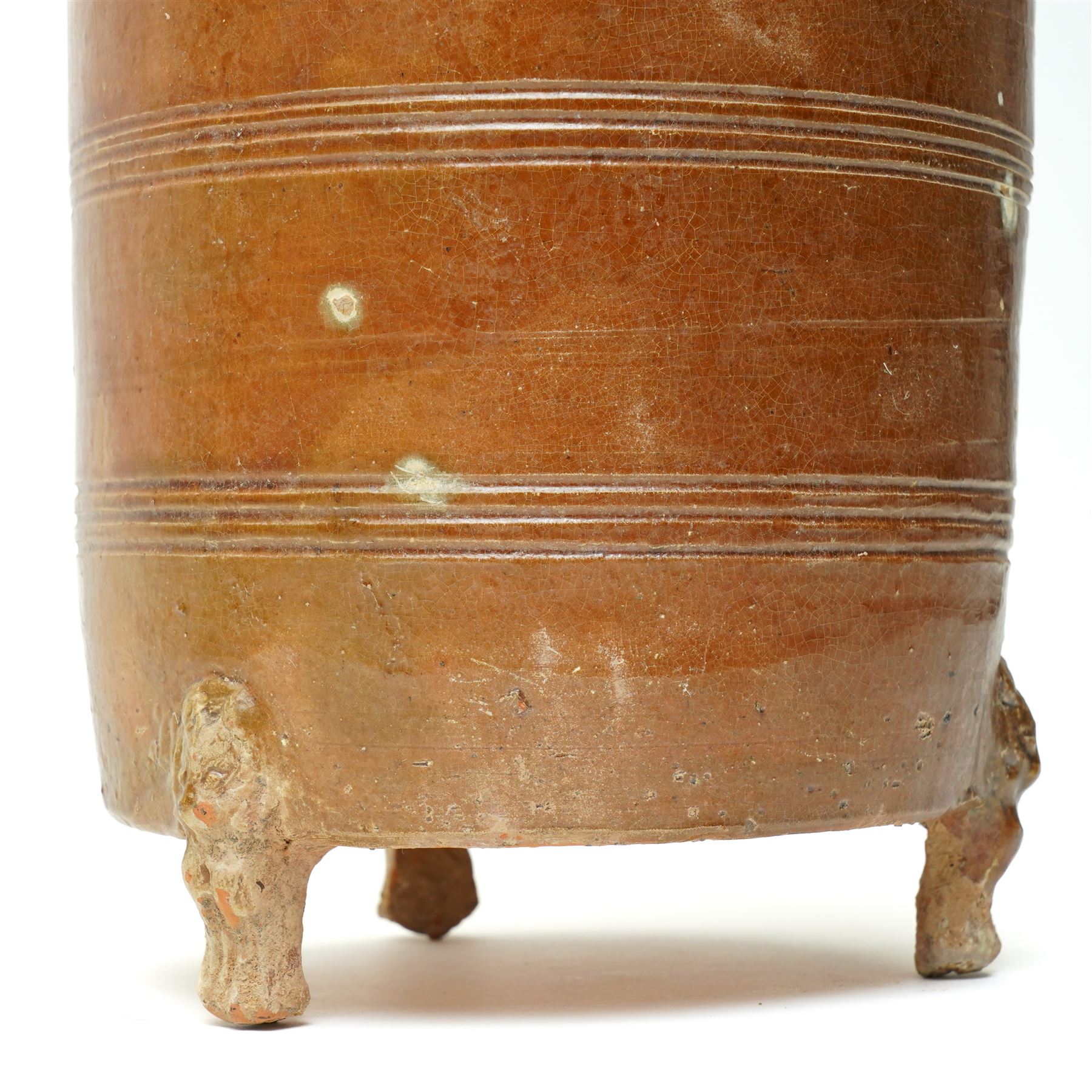 Chinese Han dynasty (202BC-9AD) brown glazed grain store, of cylindrical form, the feet formed as lions,  H26cm