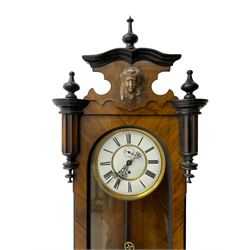 German - single train late 19th century Vienna regulator, in a walnut and ebonised case with finials and carved decoration, fully glazed case door with a visible brass weight, pendulum and beat plate, two part enamel dial with Roman numerals, pierced steel hands and subsidiary seconds dial, movement with a deadbeat escapement. 