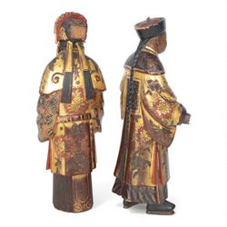 Pair of Asian carved wooden lacquered figures, in ceremonial dress, possibly wedding attire, highlighted throughout in gilt, H22cm